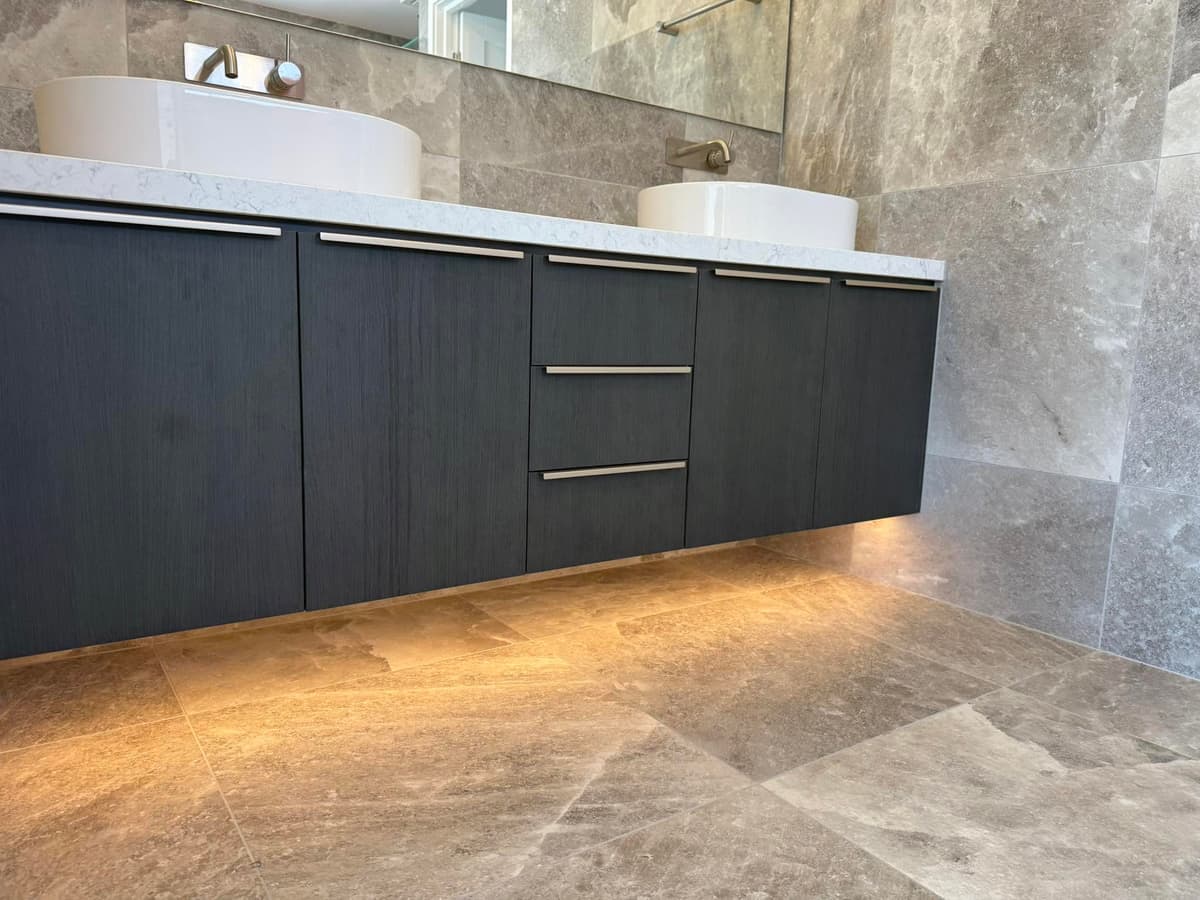 LED strip lighting under a floating bathroom vanity, installed by Wattify Electrical in Logan City