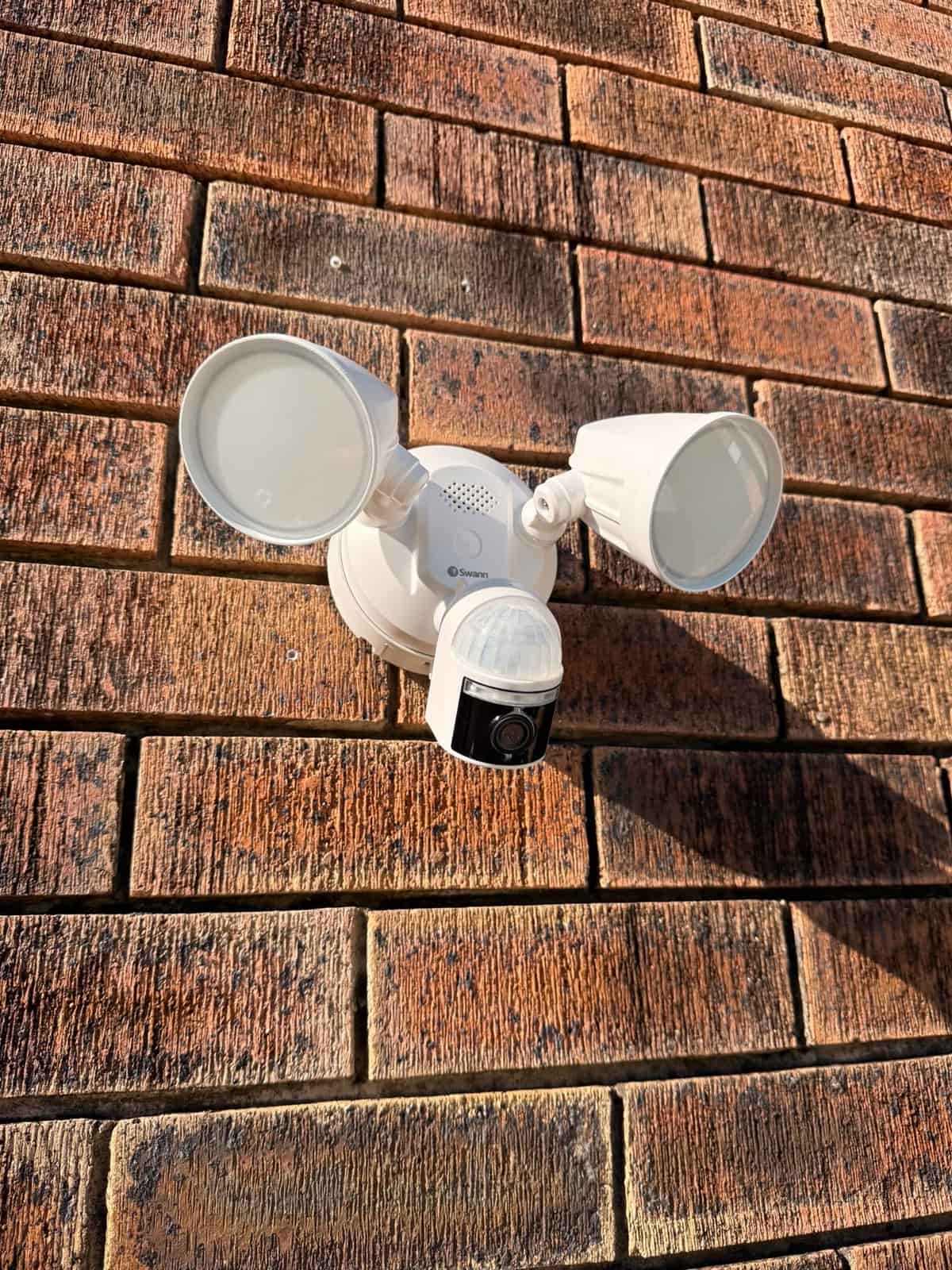 Sensor floodlight with security camera fitted to a brick wall in Logan City