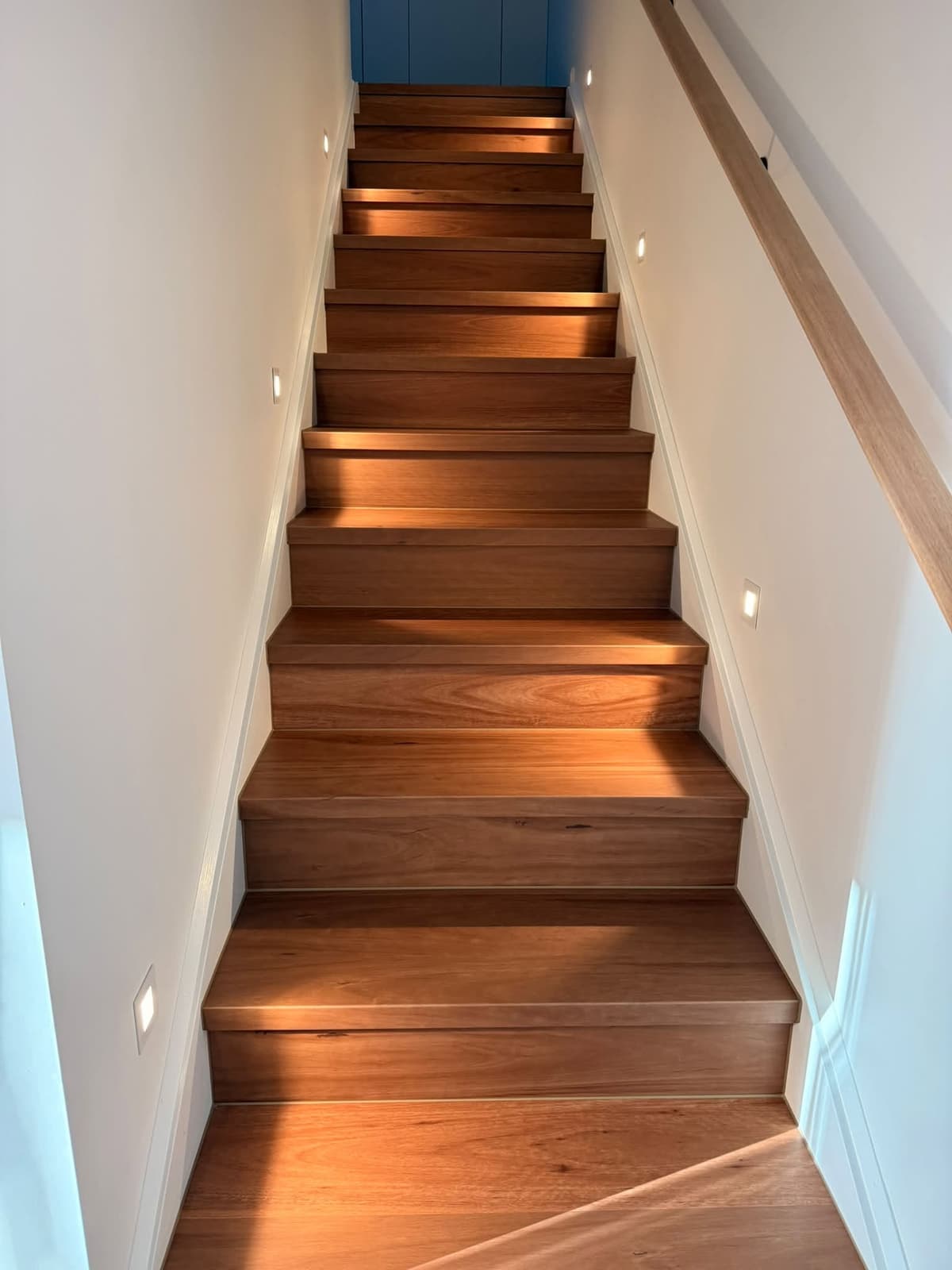 LED step lights along a timber staircase, installed by Wattify Electrical
